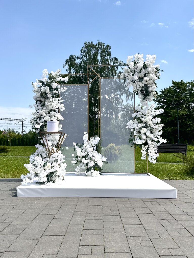 Outdoor wedding floral display and wedding ceremony backdrop